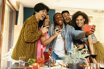 Smiling young friends taking selfie photo holding wine glasses on holiday dinner party at home