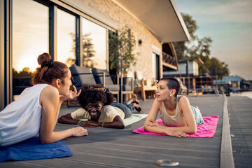 Friends relaxing and chatting on outdoor deck