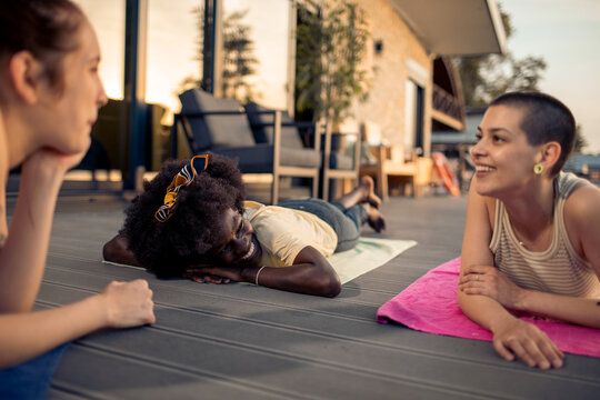 Friends relaxing and chatting on outdoor deck
