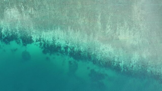 Aerial top down drone view of coral reef sea showing beautiful tropical ocean colors one side more shallow than the other located in the southwest of Thailand Phuket 4k resolution footage quality