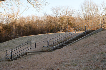 Stairs with worn handrail at sunrise on a cold winter day in Charlotte, North Carolina.