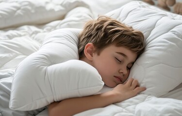 a small boy sleeping on a white pillow