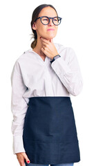 Beautiful brunette young woman wearing professional waitress apron touching painful neck, sore throat for flu, clod and infection