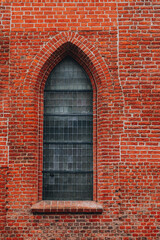 side window of a historic red brick church - Gothic style 