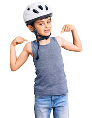 Little cute boy kid wearing bike helmet looking confident with smile on face, pointing oneself with fingers proud and happy.
