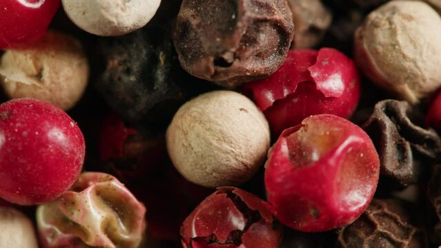 Mix dried pink, black and white pepper close-up macro. A bunch of natural pink pepper peas hot spice.Seasonings and condiments concept