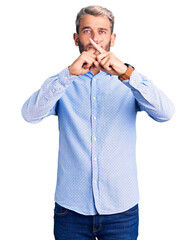 Young handsome blond man wearing elegant shirt rejection expression crossing fingers doing negative sign