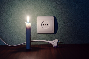 Blackout, power outage, no electricity, candle flame, socket, electrical outlet plug in pitch...
