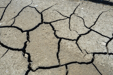 dry and cracked floor of dry river of caldera grande in the city of Barreiro with a small stream.