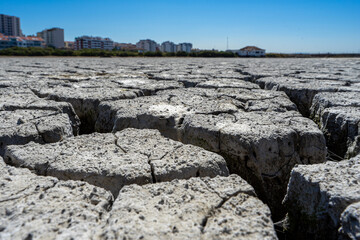 dry and cracked floor of dry river of caldera grande in the city of Barreiro with a small stream.