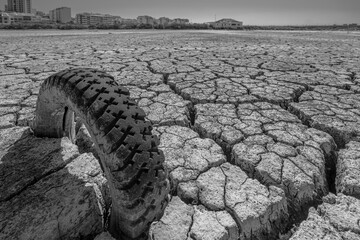 dry and cracked floor of the dry river of the big boiler in the city of Barreiro with buried old...