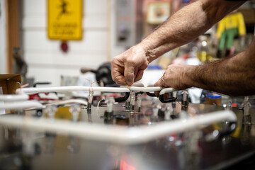 neon glass being attached to acrylic background by glass blower