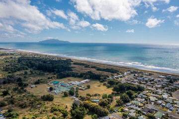 Fototapeta na wymiar An aerial shot looking south from Otaki over the flat plains and in the distance Kapiti Island. The disused health camp is seen in the foreground