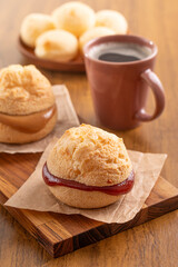 Brazilian snack. Pão de Queijo filled with guava cream (Goiabada). Breakfast. Black coffee.