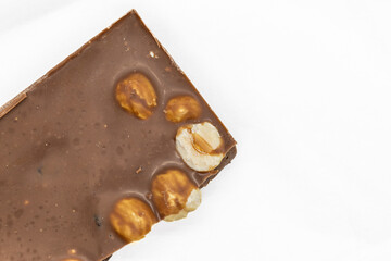 Milk Chocolate Bar with Hazelnuts on White Background