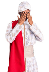 African handsome man wearing tradition sherwani saree clothes rubbing eyes for fatigue and...