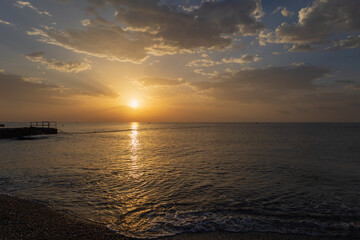Landscape by the sea in Greece on the island of Rhodes. Sunrise, dramatic clouds. Beautiful background.