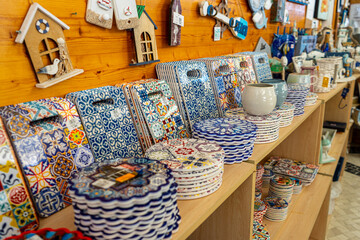 Variety of traditional earthenware cups, bowls and others handmade from varnished baked clay in Lagos, Portugal