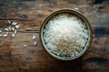 rice white raw in bowl on wooden countertop top view