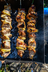 Marinated shashlik (or shish kebab) preparing on a skewers over charcoal