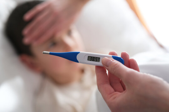 A little boy has a high temperature.