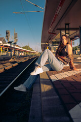Beautiful caucasian girl posing on the railway platform.