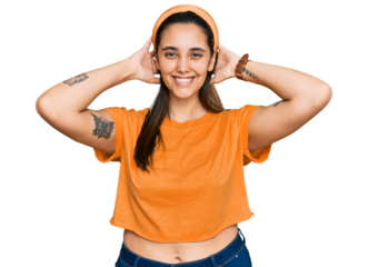 Young hispanic woman wearing casual clothes relaxing and stretching, arms and hands behind head and neck smiling happy