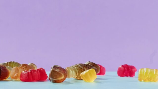 Jelly marmalade cola bottle bear falling down close up, Confiture Bean candy jujube Marmalade bears with cod cannabis close up. 