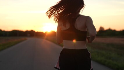 silhouette sports girl running legs along road sunset, sports track morning, jogging road, outdoor...