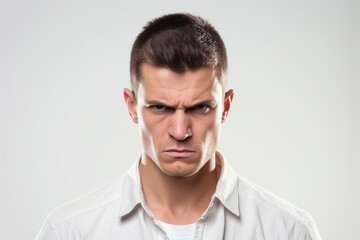 Obraz premium Portrait of young angry man on white background