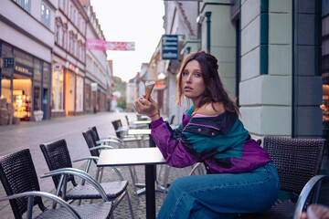 Beautiful girls posing on the street of a German town in the rays of the sunset.