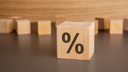 percentage sign on wooden cube with copy space
