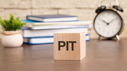 PIT written on wooden cube lying on table, business and education concept. close-up cubes - obrazy, fototapety, plakaty