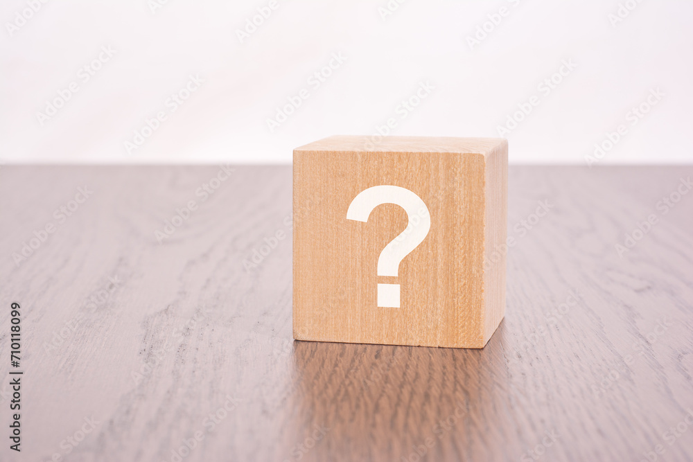 Poster one wooden block with question mark over a white background with copy space
