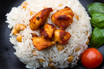Chicken pieces on rice with chickpeas