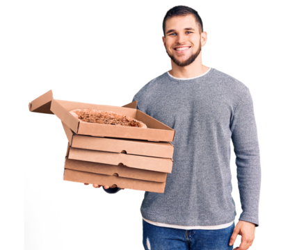 Young handsome man holding delivery italian pizza boxes looking positive and happy standing and smiling with a confident smile showing teeth