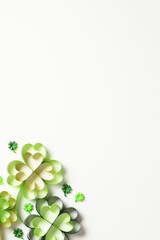 St Patrick's Day vertical banner with four leaf clover on white background. Flat lay, top view.