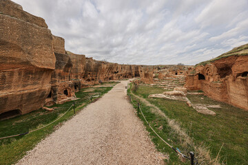 Dara ruins is an ancient city consisting of many interconnected caves in rocks. Dara Ancient City. Mesopotamia. Mardin, Turkey. The Gallery of Dara Ancient City, a huge rock-cut tomb.