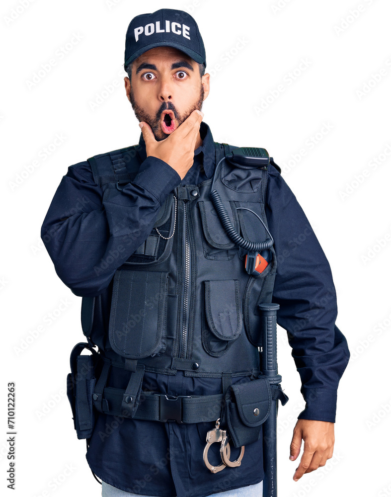 Sticker young hispanic man wearing police uniform looking fascinated with disbelief, surprise and amazed exp