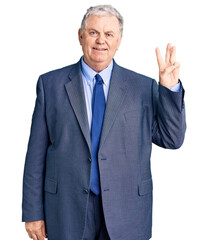 Senior grey-haired man wearing business jacket showing and pointing up with fingers number three while smiling confident and happy.