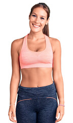 Fototapeta premium Young beautiful hispanic woman wearing sportswear with a happy and cool smile on face. lucky person.