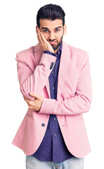 Young handsome man with beard wearing elegant jacket thinking looking tired and bored with depression problems with crossed arms.