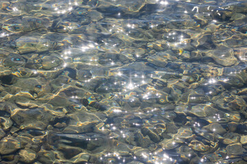 Plakat Top view of the sea rocky shore in the bright sun. Rays and glare on the water. Excellent reference for painting with caustics.