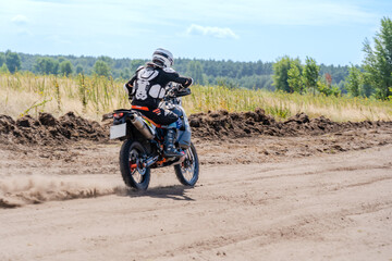 Motocross rider riding on extreme dust track