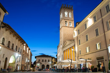 Assisi, Umbria, Italy - Square Piazza del Comune at dusk with tower Torre del Popolo and Temple of...