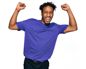 Young african american man with beard wearing casual purple t shirt celebrating surprised and amazed for success with arms raised and open eyes. winner concept.