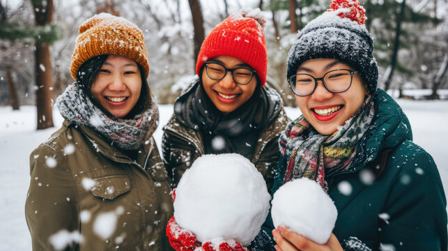 Group of three women standing next to each other in snow. This image can be used for winter-themed designs or to portray friendship and togetherness.