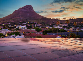 Lion's Head after sunset with solar panels on the roof reflecting the sunset sky, Cape Town, South...