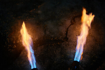 A fiery stream from a kerosene torch to snow and ice