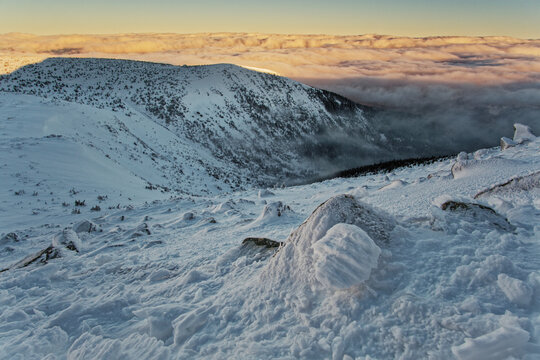 Beautiful winter in the mountains at sunrise with a sea of ​​clouds